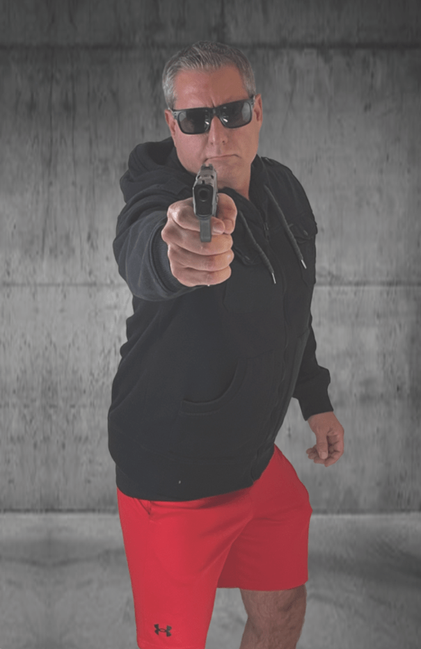 Full-color situational shooting target photo of a man in sunglasses and a black hoodie pointing a handgun straight at you