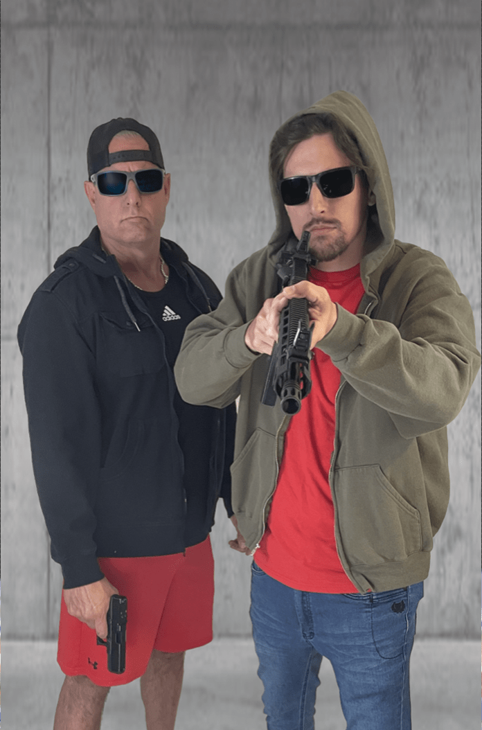 Two male criminals in hoodies and sunglasses, one shouldering a shotgun, on a full color situational target