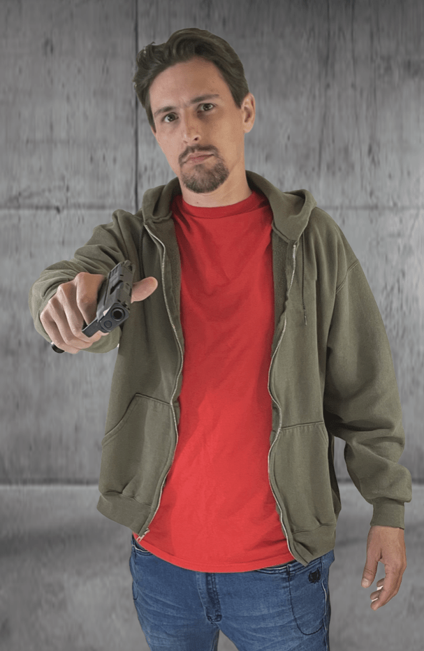 Full-color paper target of a bearded man in an olive hoodie and red shirt extending a black pistol toward the viewer