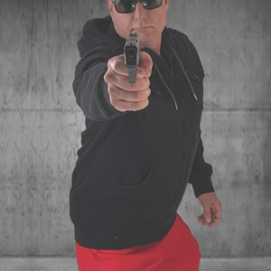 Man in sunglasses points gun at viewer