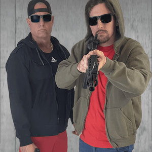 Two men with guns, posing.